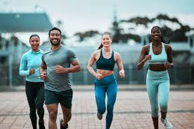 image of people running to incorporate cardio Wokingham 	 exercise into their life to help tone arms and body.